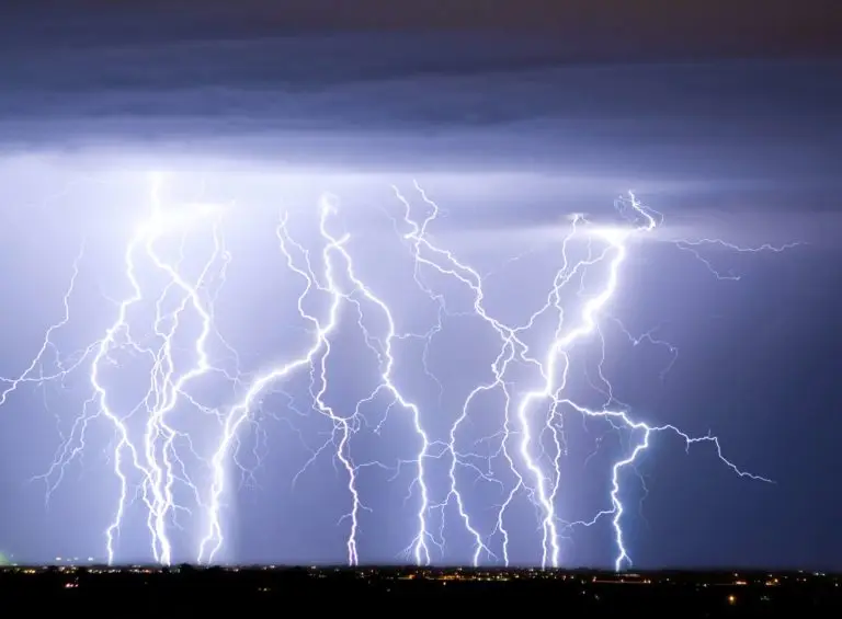 A dramatic night sky illuminated by multiple spectacular lightning strikes.